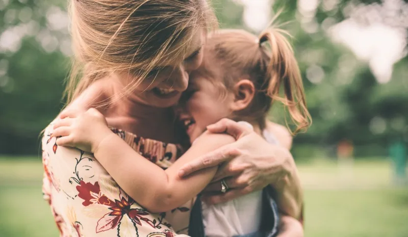 Mother hugging daugher